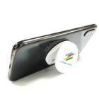 Smartphone with a pop socket stand featuring a colorful company logo.