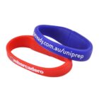Red and blue wristbands with white text, overlapping each other.