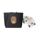 Black gift bag with a bear design and several sheets of colorful stickers displayed beside it.