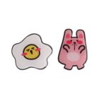 Cartoon fried egg with face next to a pink bunny with rosy cheeks.