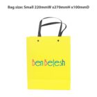 Yellow gift bag with black handles and colorful Ben Betesh text.