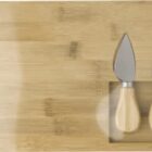 Wooden board with three cheese knives in a recessed area.