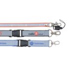 Three lanyards are shown. One is orange and white with text radio5.com.pl. Another is blue with the Masterlease logo. Each lanyard has metal clips and a plastic buckle.