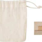 Small drawstring pouch next to a wooden puzzle on a white background.