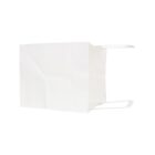 White paper bag lying on its side with handles visible.
