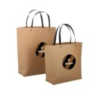 Two brown paper bags with black handles and Power logo on them.