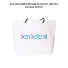 White shopping bag with Ben Betesh logo and black handles.