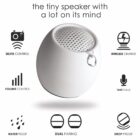 White spherical portable speaker with icons for features like waterproof and wireless charge.