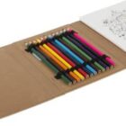 A set of colored pencils and a coloring book in an open brown folder.