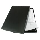 A black rectangular box with a white cloth partially covering a dark object inside. The lid is slightly ajar, showing the contents within. The setting is against a plain white background.