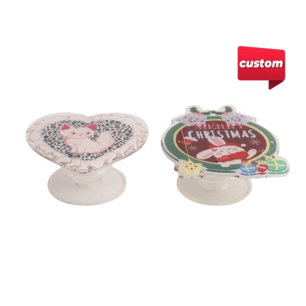 Two custom pop sockets: a heart with a cat and a Christmas-themed design.