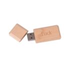 Wooden USB flash drive with luck engraved, cap placed beside it.