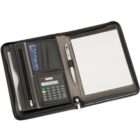 A black leather portfolio folder is open, displaying a lined notepad on the right and a pen clipped to the folder. The left side includes a calculator, business card slots, and a zippered pouch.