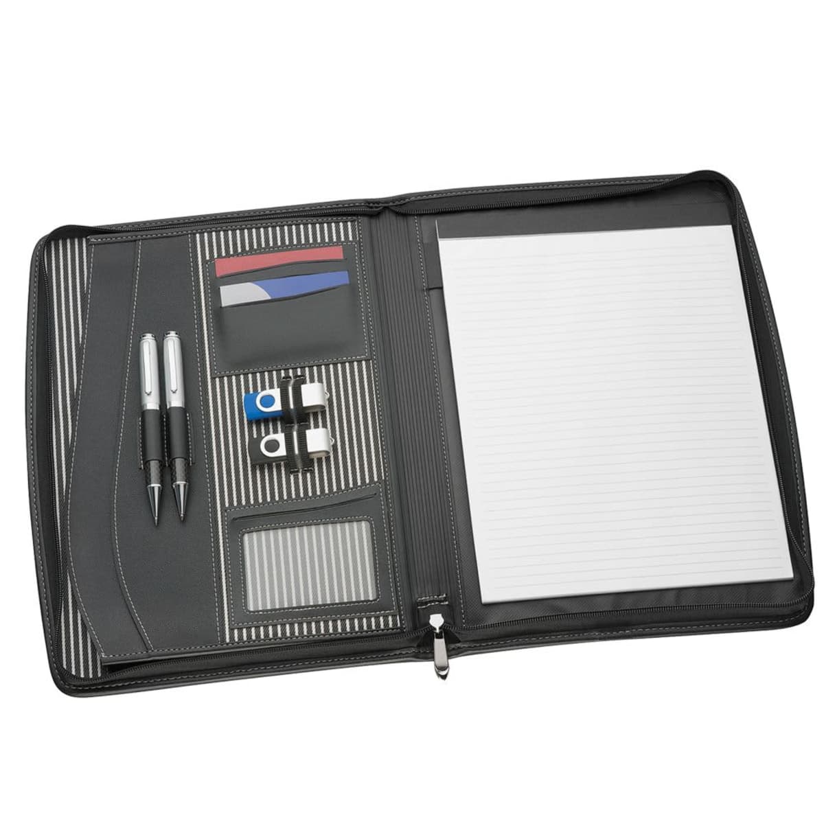 An open black organizer with a lined notepad on the right. The left side has slots for cards, two pens, and two USB drives. The interior features a black and white striped fabric design.