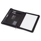 Open black zippered portfolio with a spiral notebook, three metal pens, a business card, and a slot for papers. The interior is organized with various compartments for office essentials.