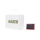 White paper bag with WRATH text; small red-framed device beside it.