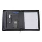 An open black leather portfolio displaying two pens, a pocket calculator, and a notepad with lined paper. There is also a section with a pocket holding a blue paper, possibly for documents.