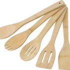 Five wooden kitchen utensils arranged fan-like on a white background.