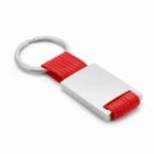 Silver keyring with a rectangular metal plate and a red fabric loop.