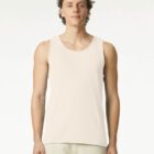 Man wearing a light beige tank top and pants, standing against a plain white background.