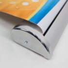 A retractable banner stand with a partially visible banner.