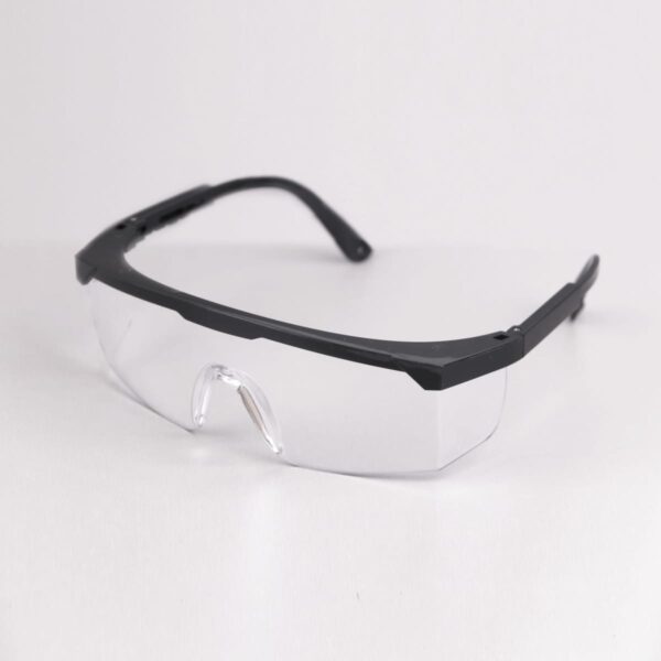 Clear safety glasses with black frames on a light surface.