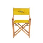 A yellow directors chair with Team Pro printed on the backrest. The chair has wooden frame and foldable design, with yellow fabric seat and backrest featuring a subtle pattern.
