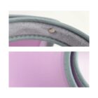 Close-up of a pink and gray fabric with detailed stitching and a metal button.