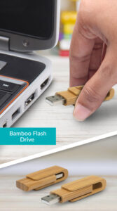 A hand inserts a bamboo flash drive into a laptop. Below, two bamboo flash drives with slide covers are displayed on a surface. A label reads Bamboo Flash Drive, showcasing these bulk promotional USB drives as a cost-effective marketing solution.