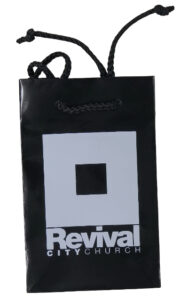 Black laminated carry bag branded with Revival City Church logo.