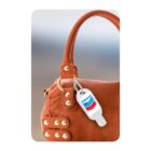 Brown handbag with a Chevron keychain attached to the handle.
