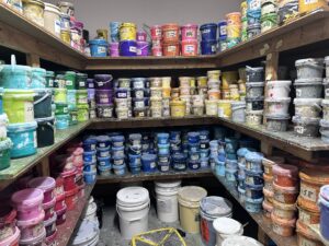 A room filled with hundreds of tubs of ink. This ink is used for screen printing.