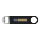 A black bottle opener featuring a silver metal tip for opening bottles. The handle displays a label with the text 1396 PREMIUM LAGERBIER in blue and gold. There is a round hole on the opposite end of the opener.