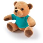 Plush brown teddy bear wearing a teal shirt, sitting upright on a white background.