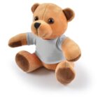 Brown teddy bear wearing a plain white t-shirt, sitting on a white background.