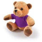 A brown teddy bear wearing a purple shirt, sitting upright on a white background.