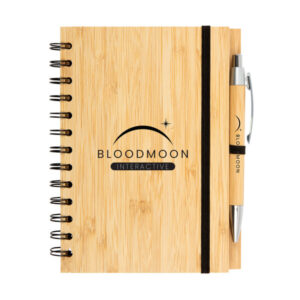 Wooden notebook with pen, perfect for diaries, labeled Bloodmoon Interactive with a crescent and star.