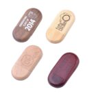 Four branded wooden USB drives with various engravings and colors.