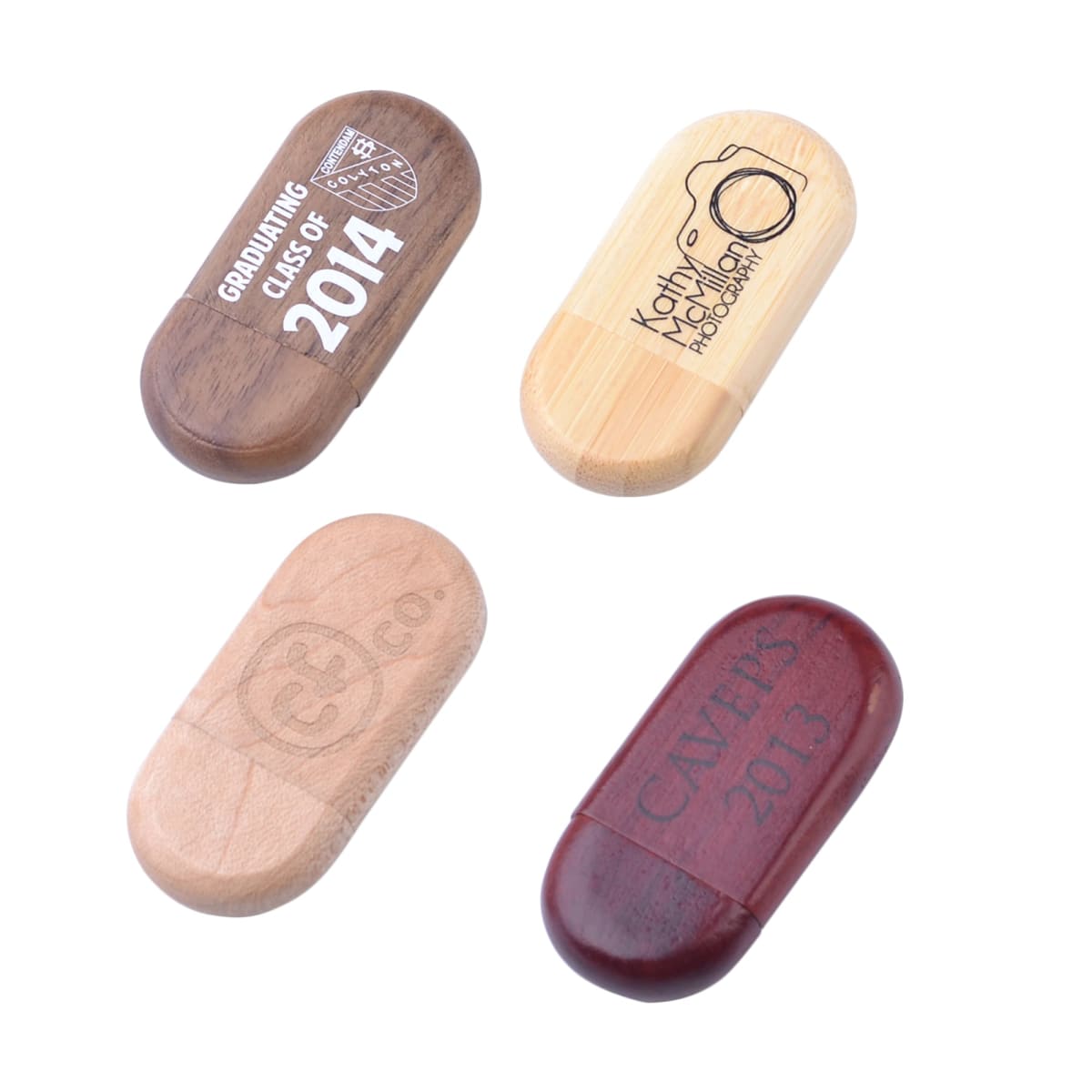 Four branded wooden USB drives with various engravings and colors.