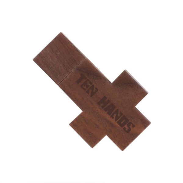 Wooden cross-shaped object with TEN HANDS engraved on it.