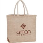 Beige tote bag with aman SPA & RESORT and a floral logo printed on it.