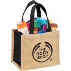 Canvas tote with The Body Shop logo filled with cosmetics and beauty products.