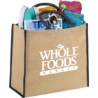 Jute bag with Whole Foods Market logo, filled with magazines, towel, and sunglasses.