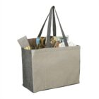 Gray tote bag filled with a magazine, a tube, and tissue paper.