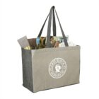 Gray tote bag filled with magazines, a book, a tube, and tissue paper.