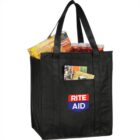 Black Rite Aid tote bag filled with groceries, including a Lunchables box.