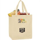 Beige Rite Aid tote bag filled with groceries, including a Lunchables box.