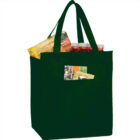 Reusable bag with assorted groceries, including snacks and jars, with long handles.