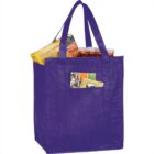 Purple reusable shopping bag with groceries, including soda cans and a Lunchables box.
