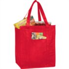 Red reusable grocery bag with snacks and jars peeking out.